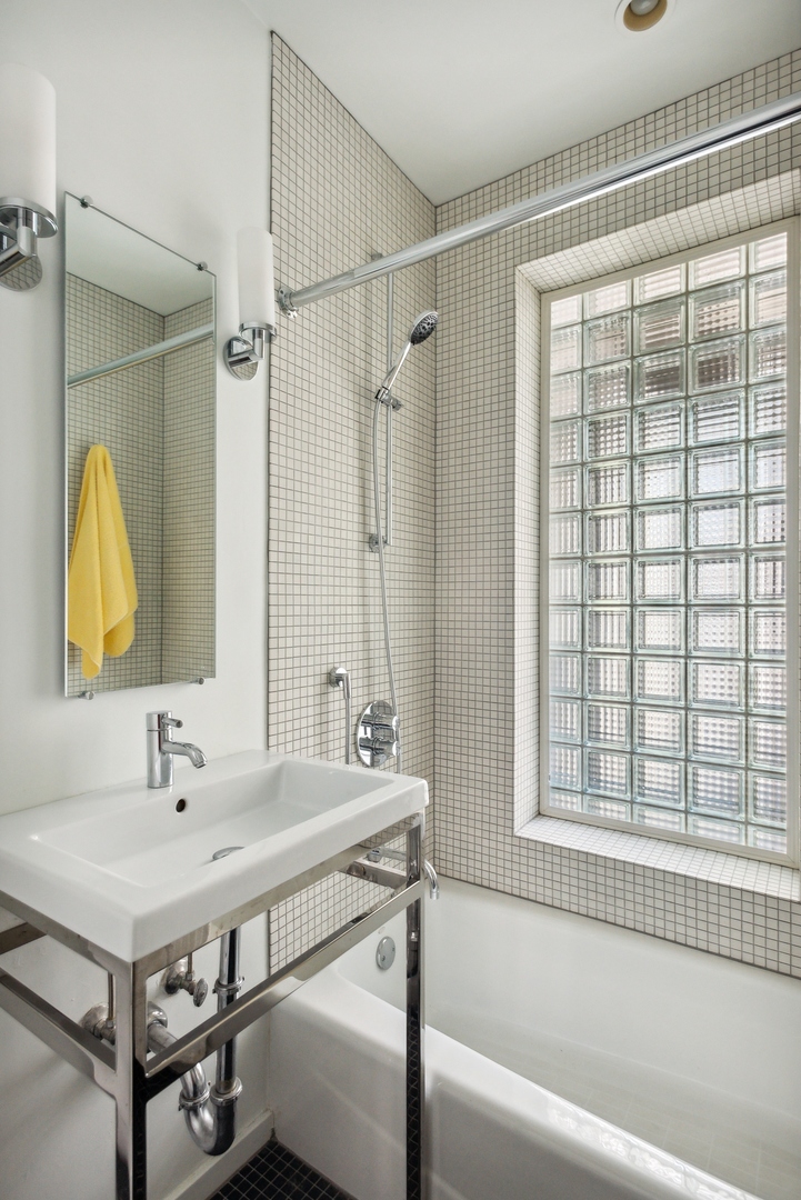 1209 North State Parkway, Unit 13 Chicago, IL 60610 - Photo 24 of 37 a bathroom with a sink and a bathtub