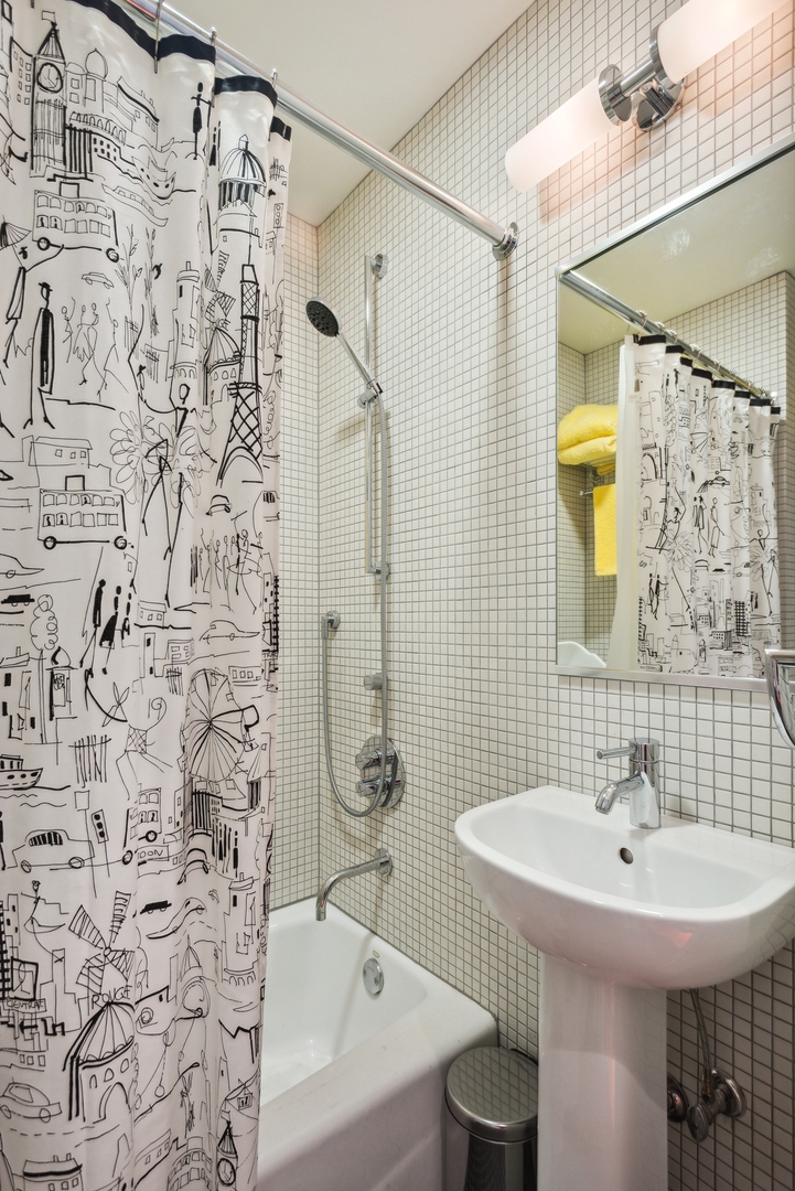 1209 North State Parkway, Unit 13 Chicago, IL 60610 - Photo 30 of 37 a bathroom with a sink a toilet and shower