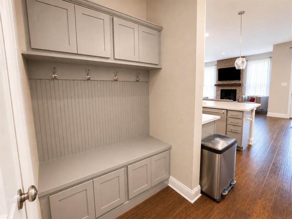 8235 Snapdragon Way Dallas, TX 75252 - Photo 12 of 29 Built-in entryway storage with upper cabinetry, beadboard backing, and bench seating with integrated lower storage