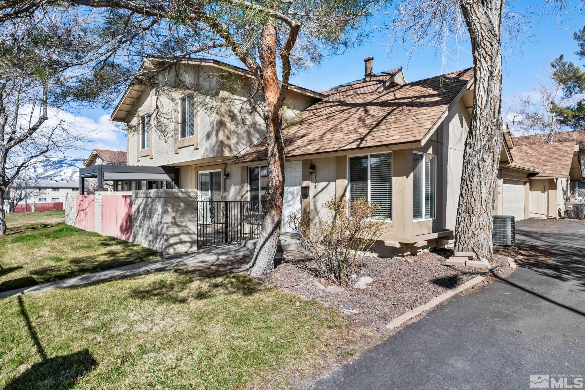 a view of a house with large trees