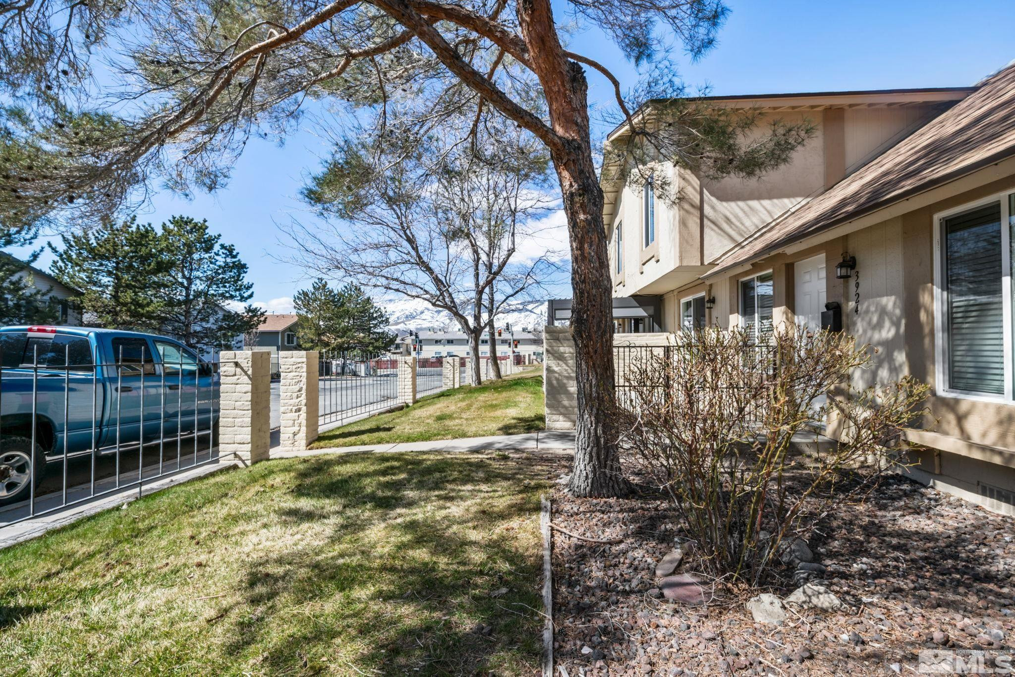 3924 Pheasant Drive Carson City, NV 89701 - Photo 11 of 38 a view of backyard with wooden fence and a large tree