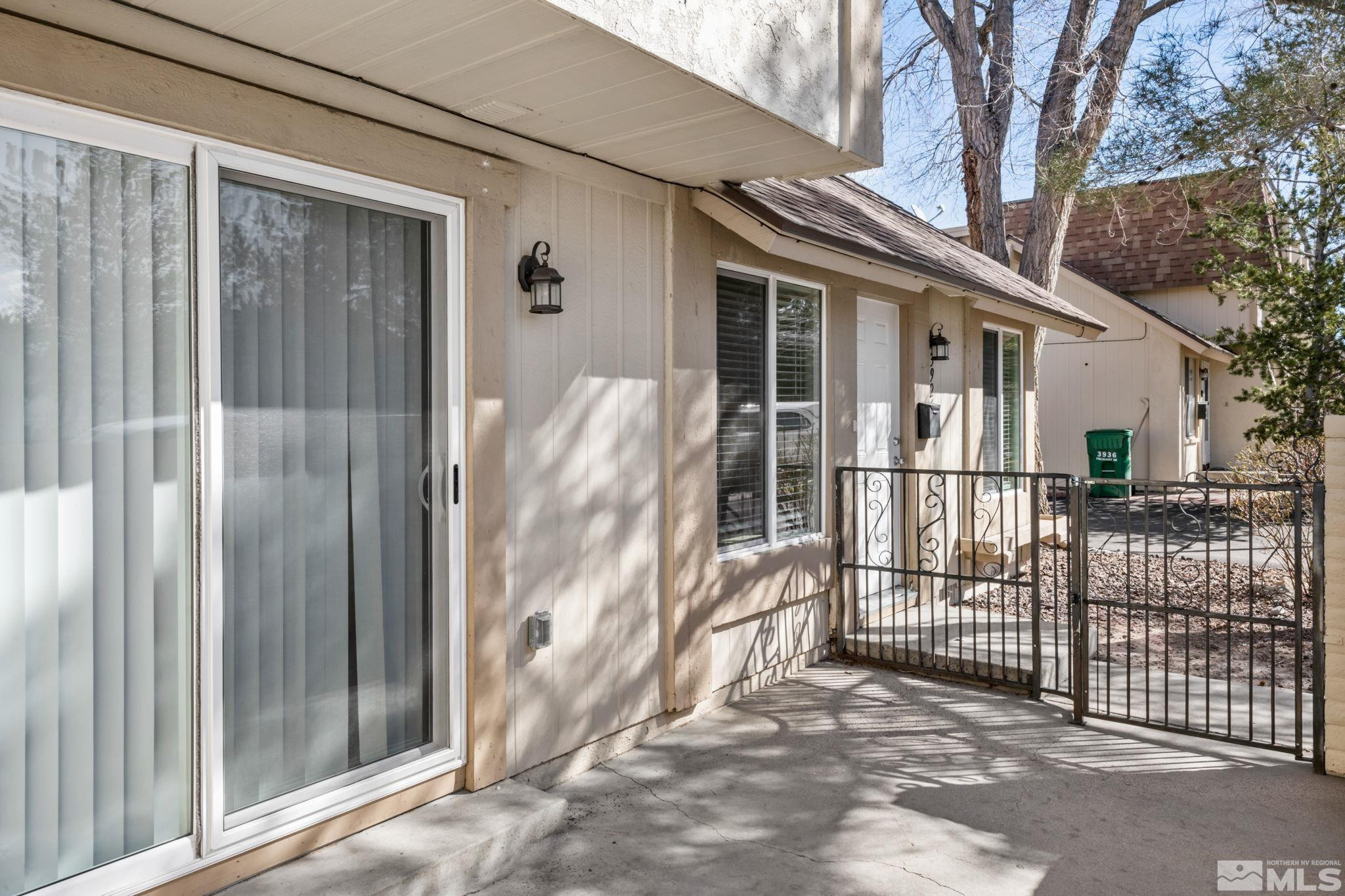 3924 Pheasant Drive Carson City, NV 89701 - Photo 12 of 38 a view of a house with a small yard and wooden fence and a large window