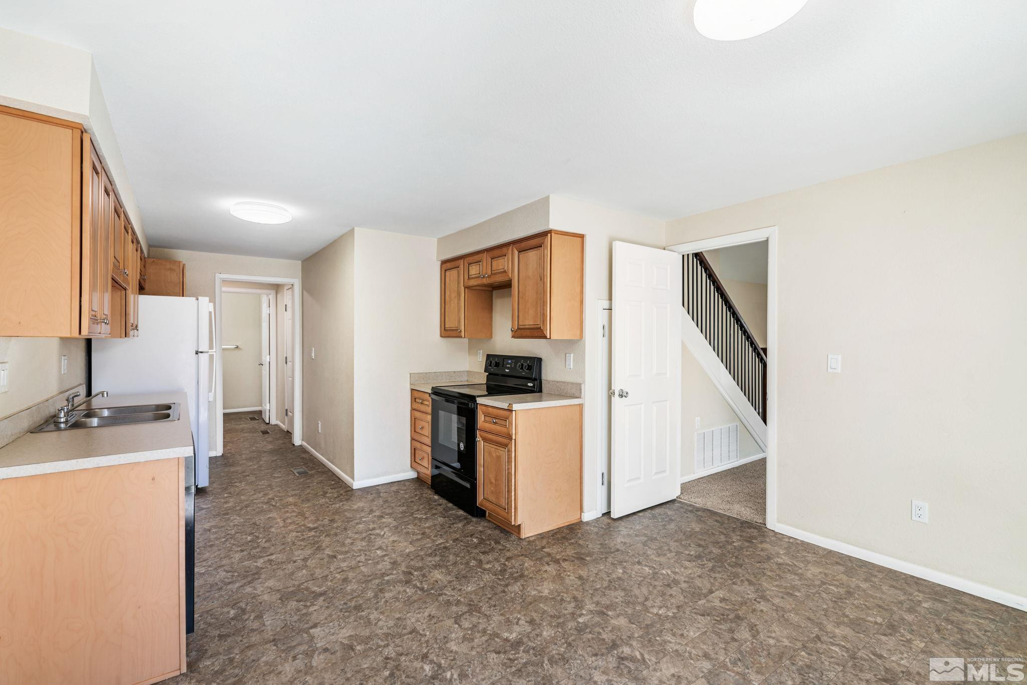 3924 Pheasant Drive Carson City, NV 89701 - Photo 18 of 38 a view of a kitchen with a sink fridge and wooden floor
