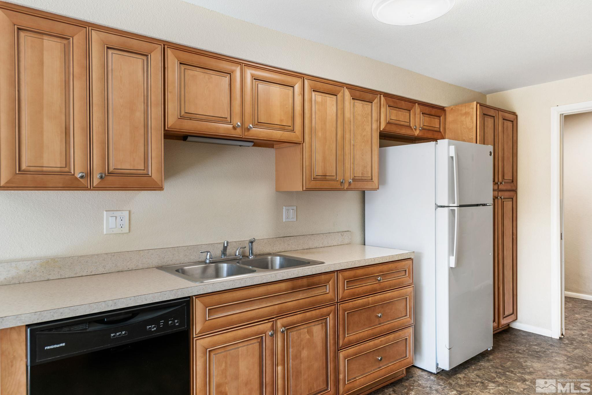 3924 Pheasant Drive Carson City, NV 89701 - Photo 19 of 38 a kitchen with stainless steel appliances granite countertop a refrigerator sink and cabinets