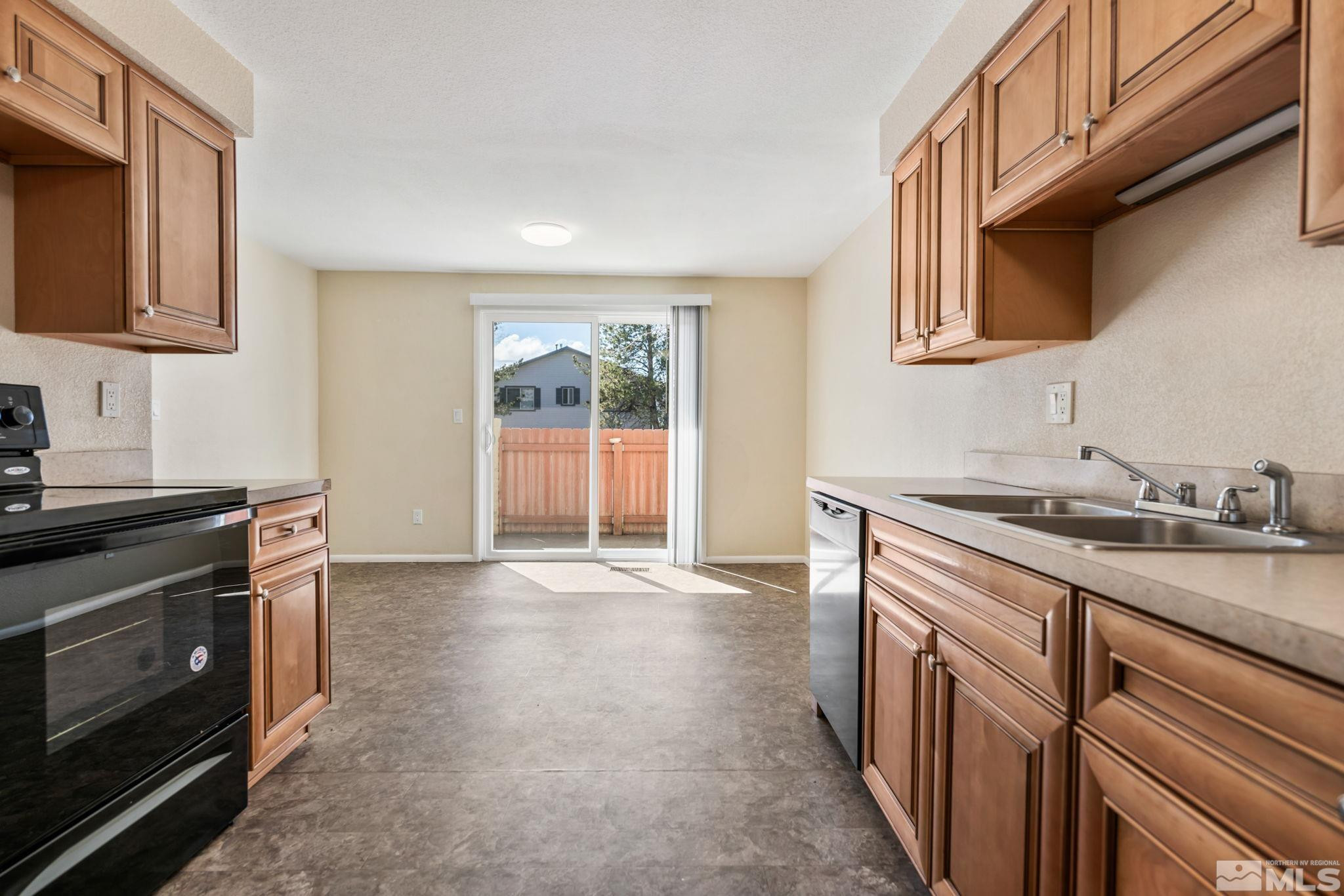 3924 Pheasant Drive Carson City, NV 89701 - Photo 23 of 38 a kitchen with stainless steel appliances granite countertop a sink stove and cabinets