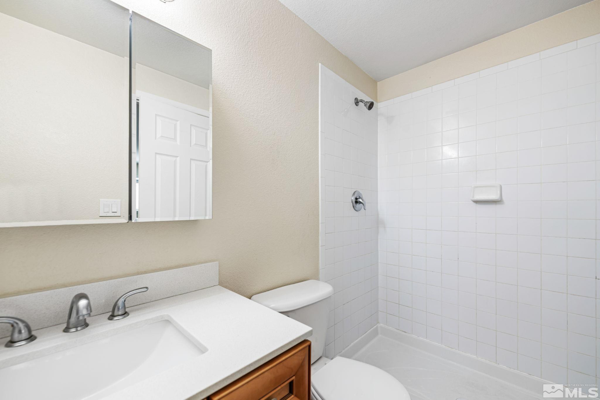 3924 Pheasant Drive Carson City, NV 89701 - Photo 29 of 38 a bathroom with a sink toilet and shower
