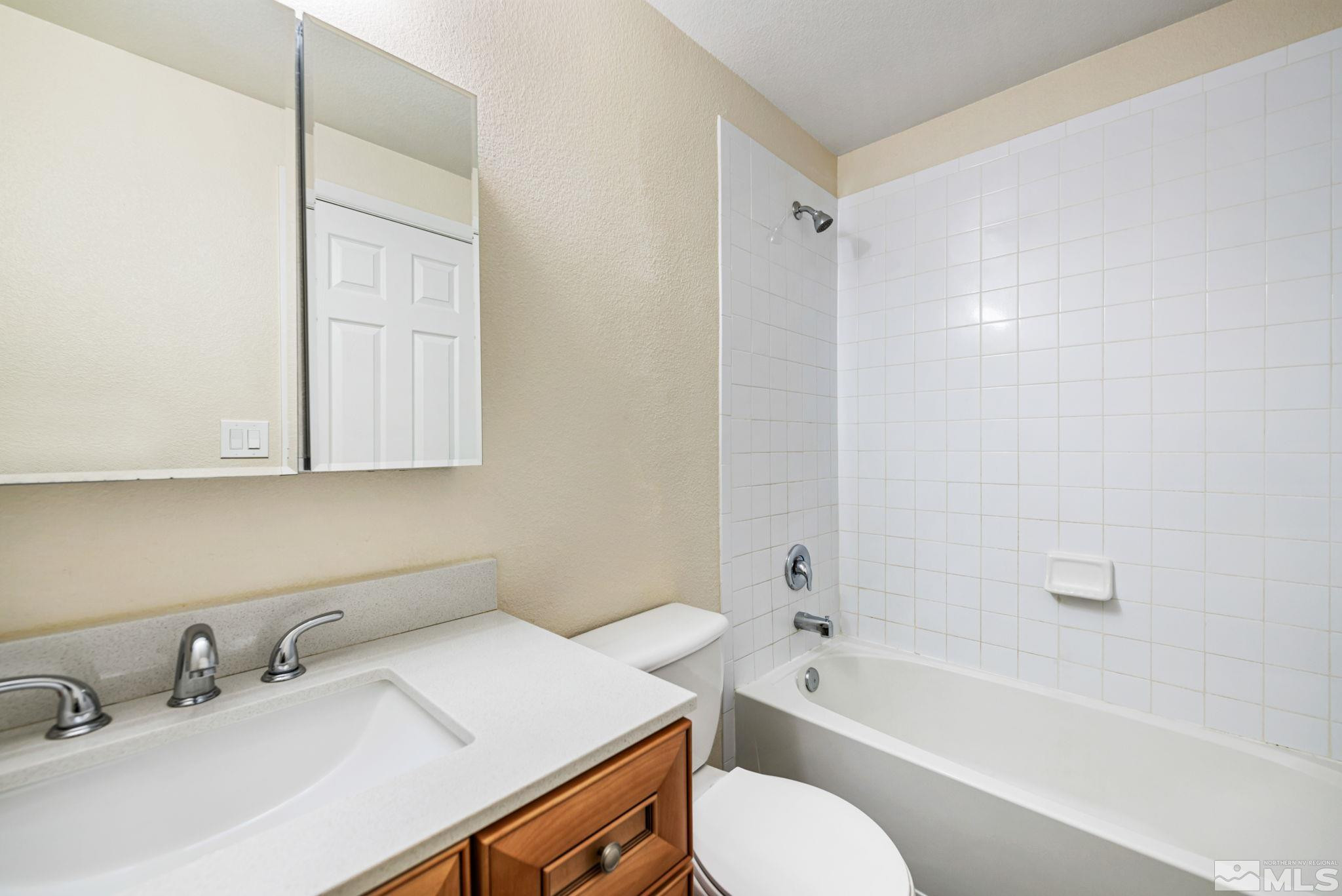 3924 Pheasant Drive Carson City, NV 89701 - Photo 35 of 38 a bathroom with a granite countertop sink toilet and shower