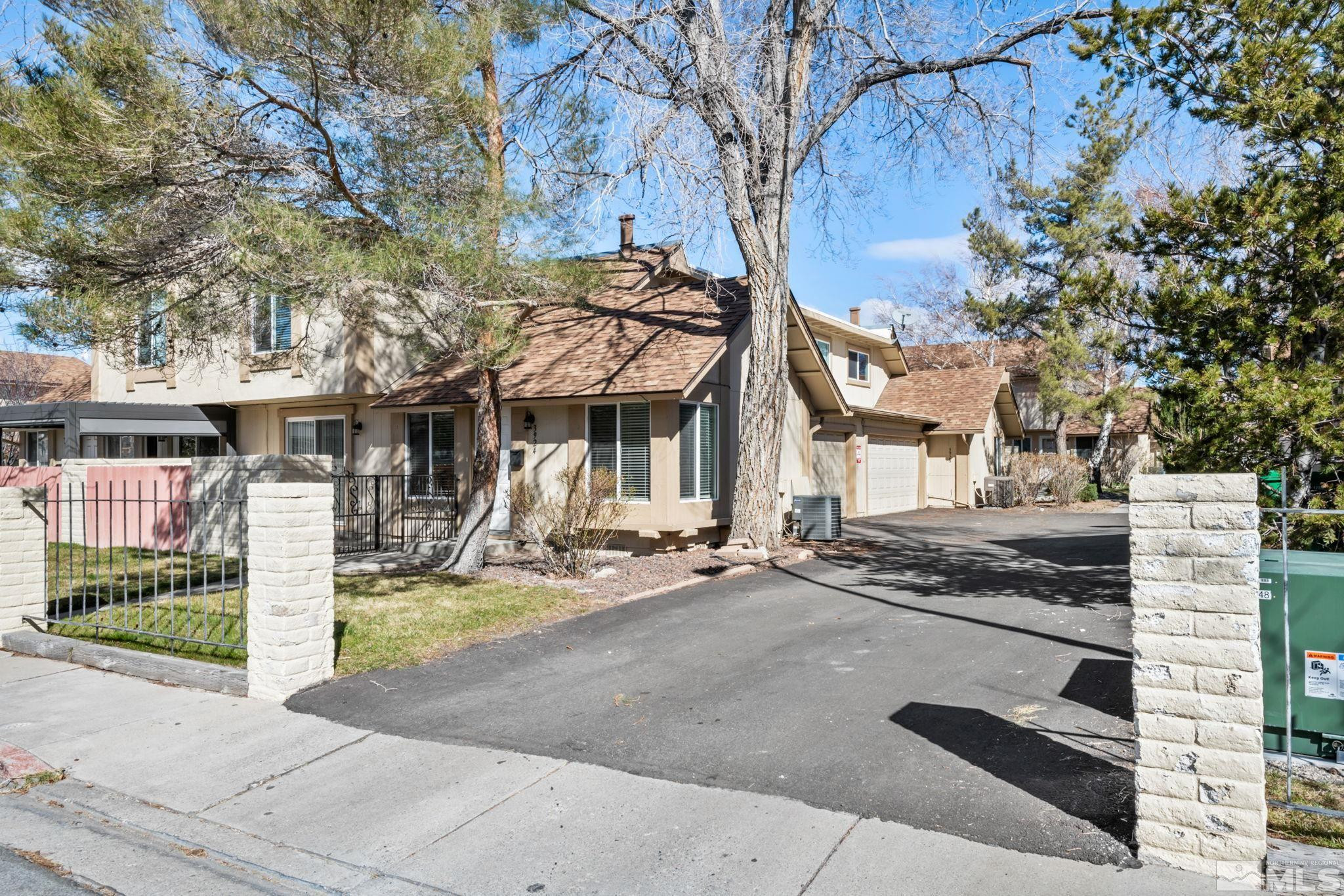 3924 Pheasant Drive Carson City, NV 89701 - Photo 6 of 38 a view of a house with a tree and wooden fence