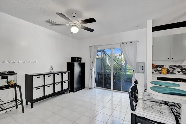 a bedroom with furniture and a large window