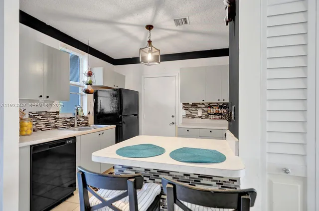 a kitchen with stainless steel appliances granite countertop a stove and a refrigerator