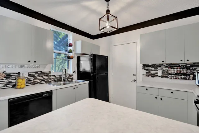 a kitchen with a sink stove and refrigerator