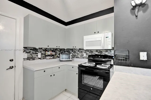 a kitchen with granite countertop a stove and a sink
