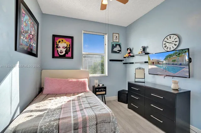 a bedroom with a bed and paintings on the wall