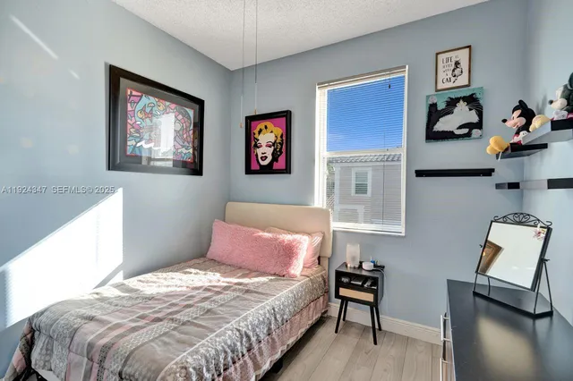 a bedroom with bed and furniture