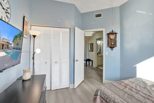 a bedroom with a bed and a view of bathroom