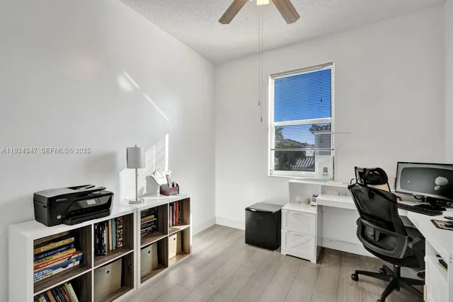a view of a workspace with furniture and wooden floor