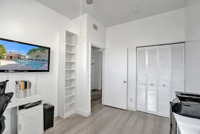 a view of room with hardwood floor and closet