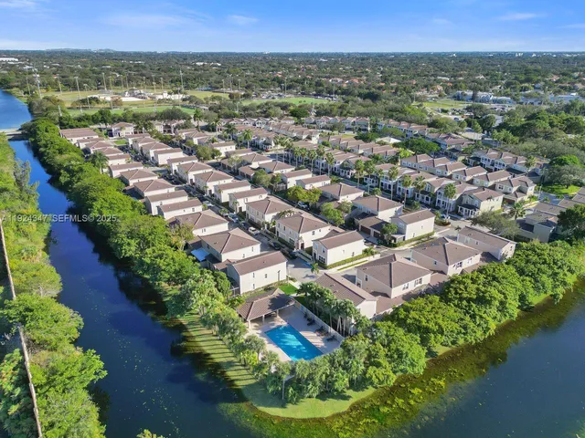 an aerial view of a house with a yard