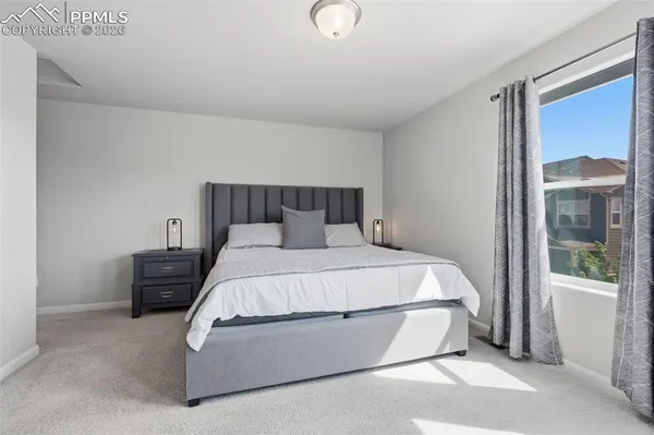a bed room with a bed and a lamp