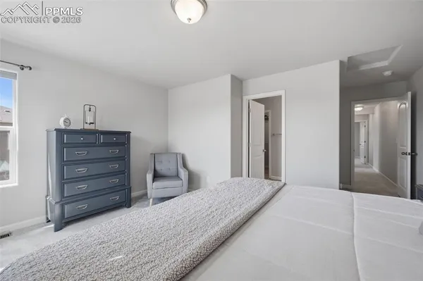 a bedroom with a bed and a dresser