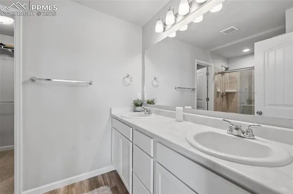 a bathroom with a sink double vanity and a mirror