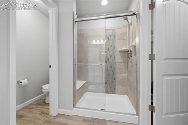 a bathroom with a glass door shower