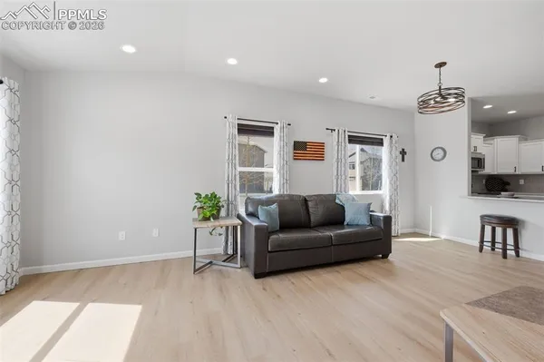 a living room with furniture and a wooden floor