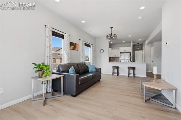 a living room with furniture and kitchen view