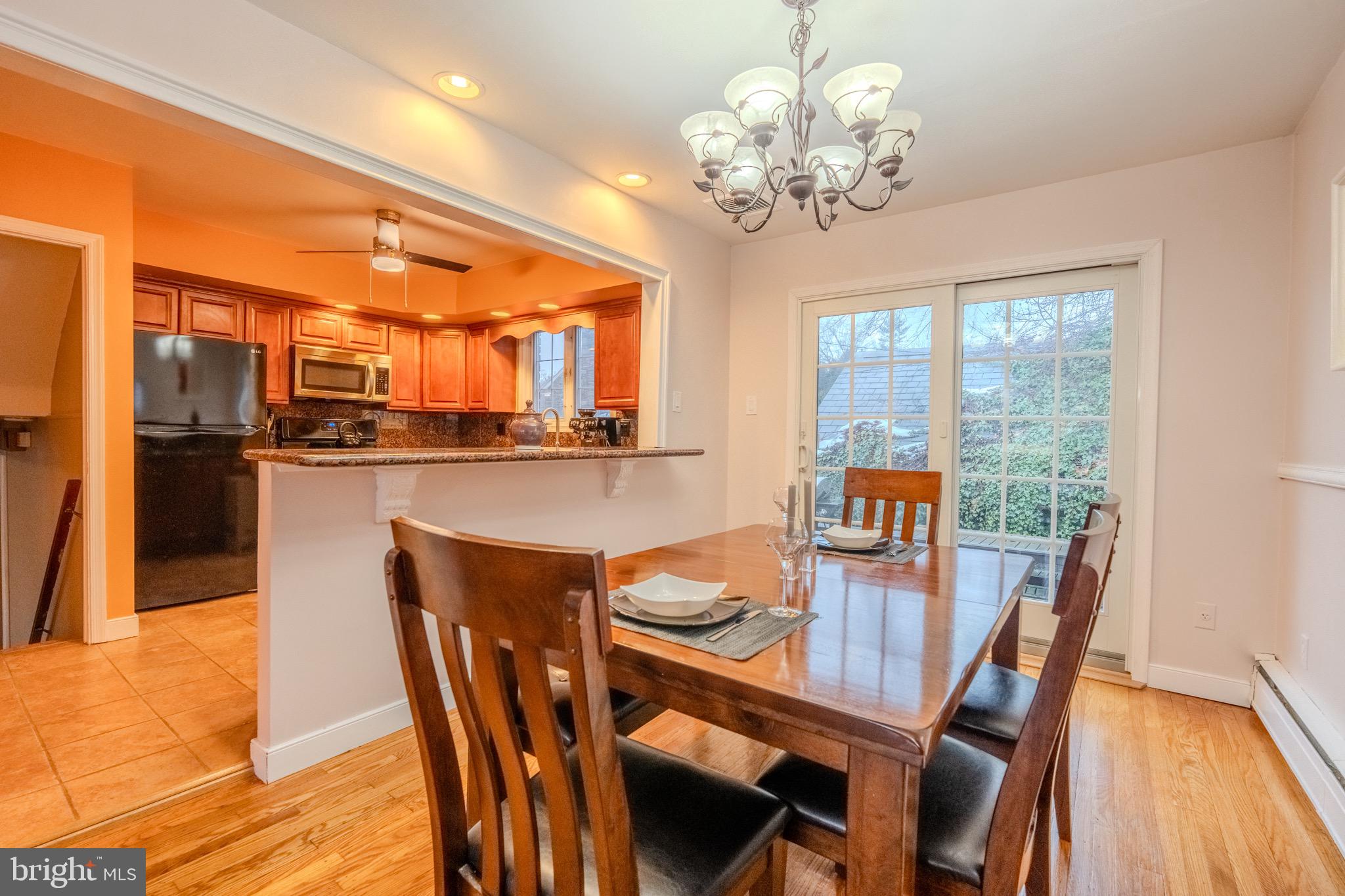613 Seville Street Philadelphia, PA 19128 - Photo 11 of 37 a view of a dining room with furniture a chandelier and wooden floor