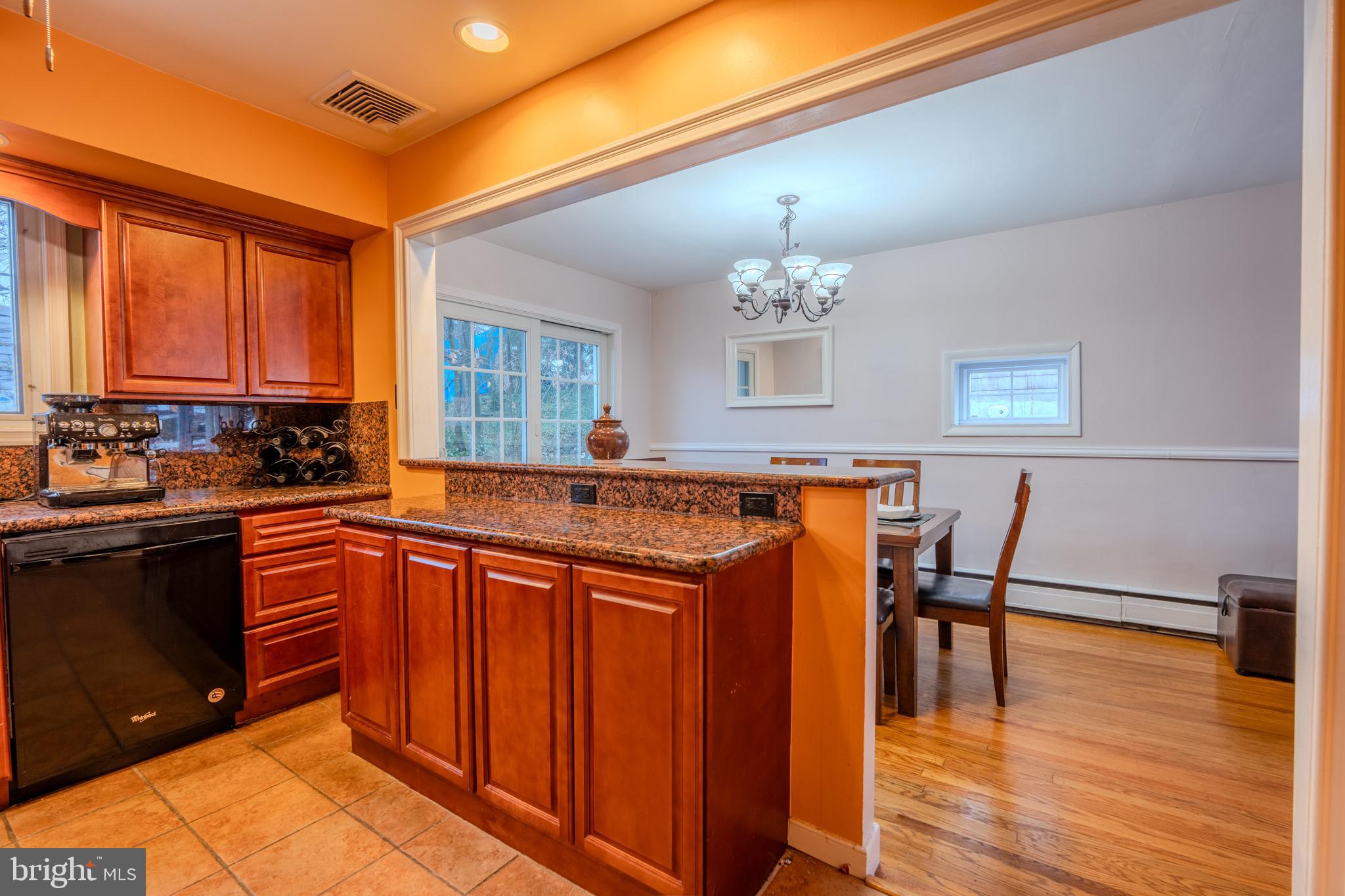 613 Seville Street Philadelphia, PA 19128 - Photo 15 of 37 a kitchen with stainless steel appliances granite countertop a stove a sink dishwasher and a refrigerator with wooden floor