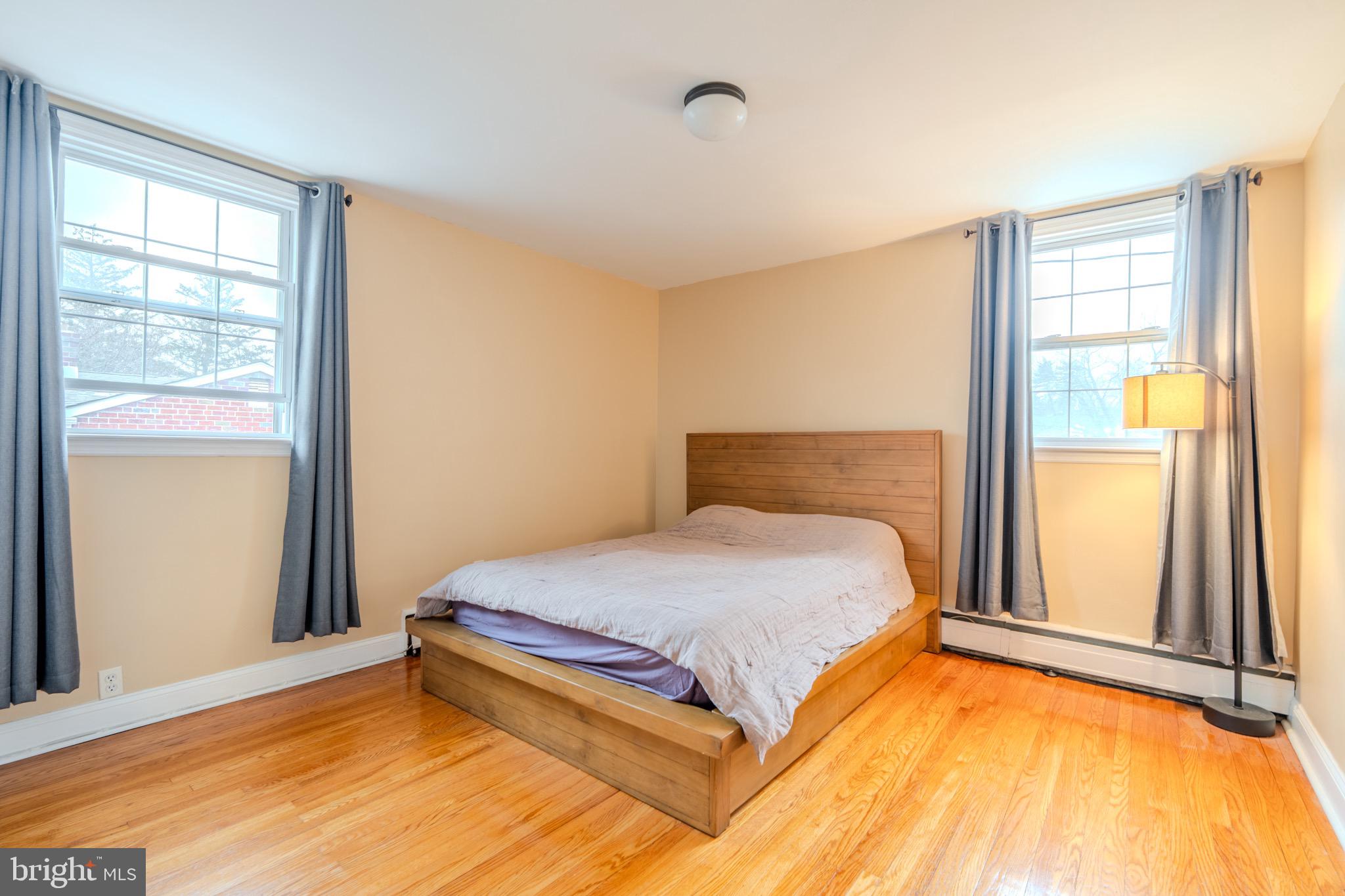 613 Seville Street Philadelphia, PA 19128 - Photo 22 of 37 a bedroom with a bed and wooden floor