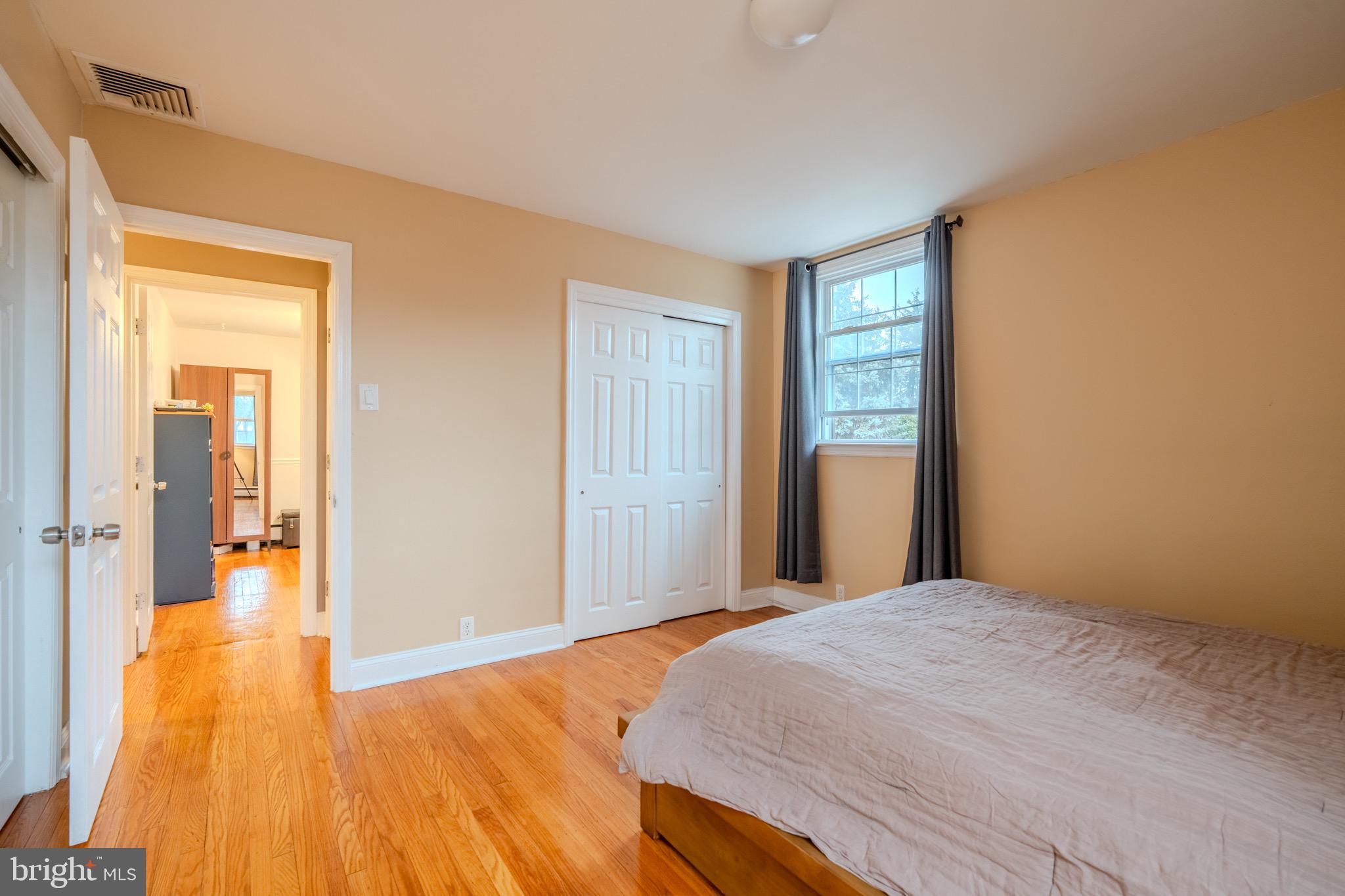 613 Seville Street Philadelphia, PA 19128 - Photo 23 of 37 a bedroom with a bed and wooden floor