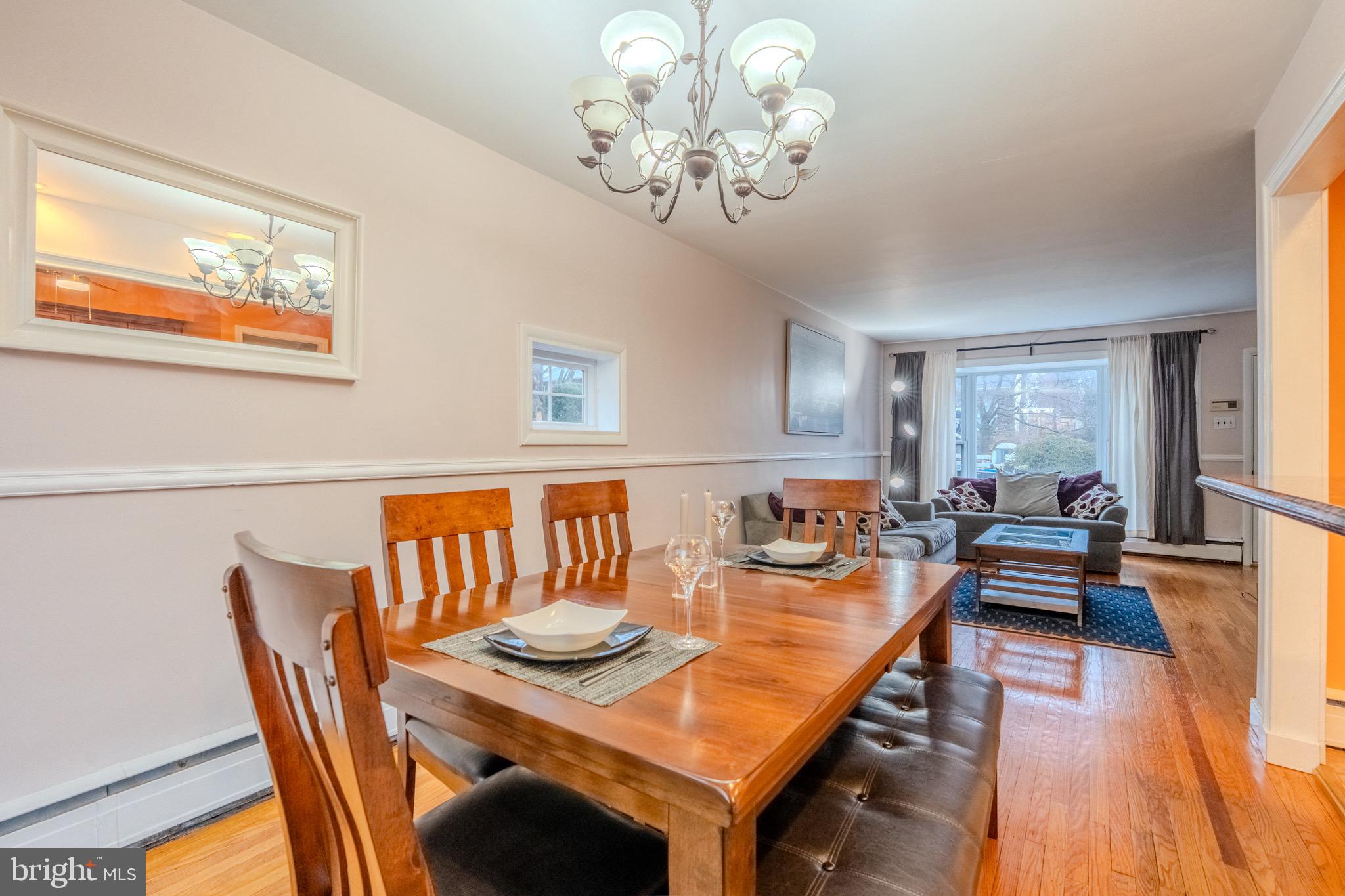 613 Seville Street Philadelphia, PA 19128 - Photo 10 of 37 a dining room with furniture a chandelier and wooden floor