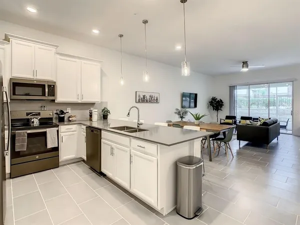 a kitchen with a sink and a stove top oven