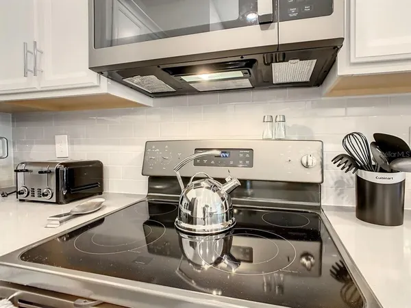 a kitchen with a stove and a microwave