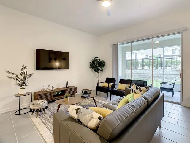 a living room with furniture and a flat screen tv