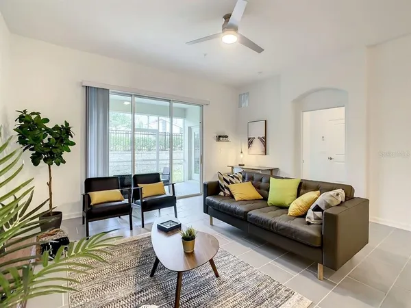 a living room with furniture and a potted plant