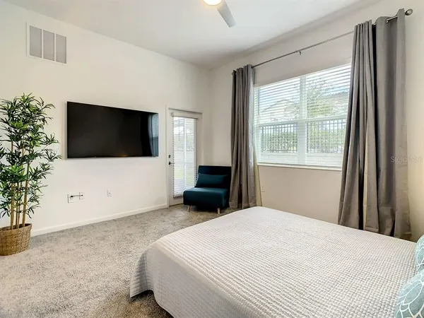 a bedroom with a bed and a flat screen tv