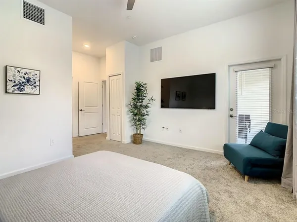 a bedroom with a bed and a flat screen tv