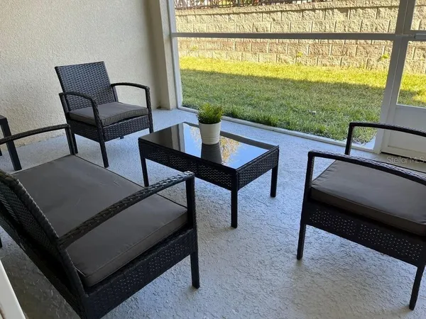 a living room with furniture and a floor to ceiling window