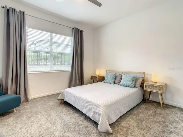 a bedroom with a bed and a window