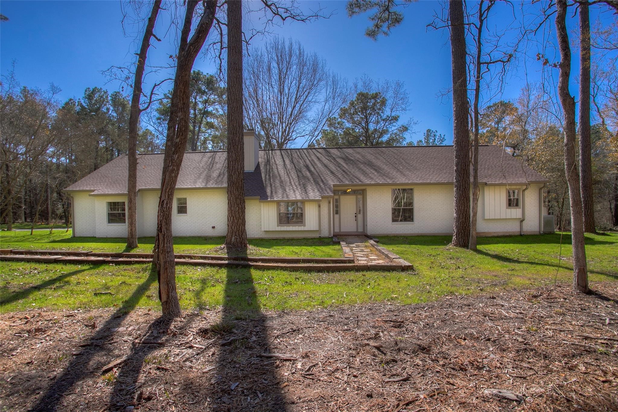 83 Dahlia Road Huntsville, TX 77320 - Photo 41 of 49 a front view of a house with a yard