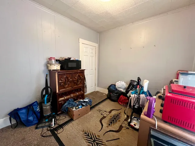 a kitchen with a dining table chairs and a refrigerator