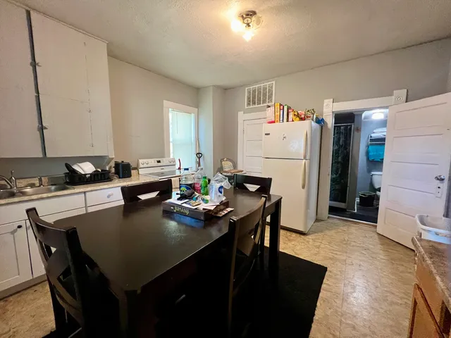 a bedroom with a bed and a flat tv screen on a dresser