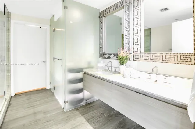 a spacious bathroom with a double vanity sink and a mirror