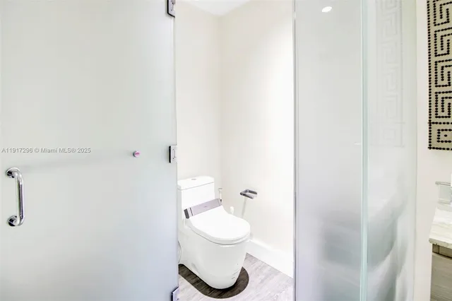 a bathroom with a toilet and a shower