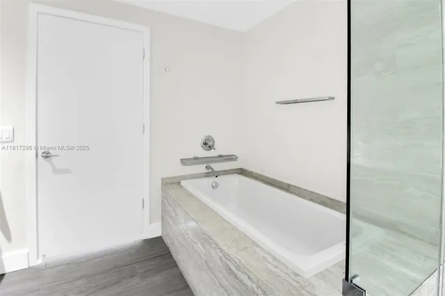 a bathroom with a tub and sink