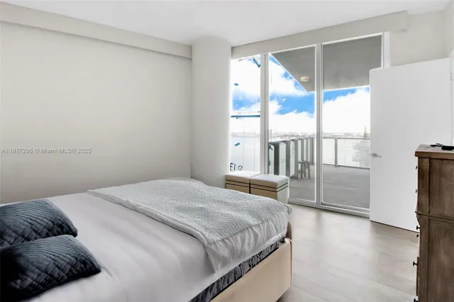 a bedroom with a bed and a large window