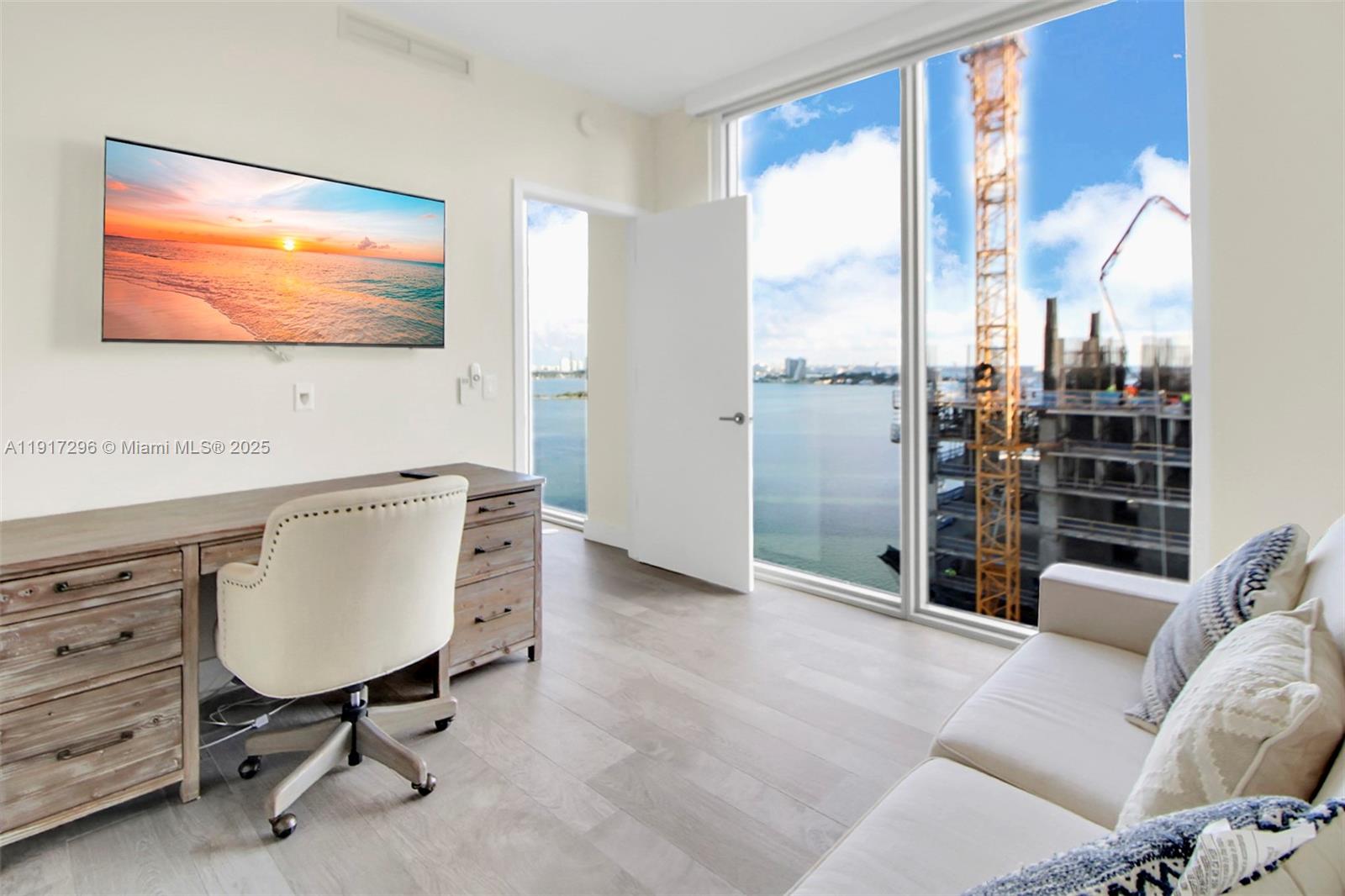2900 Northeast 7th Avenue, Unit 1807 Miami, FL 33137 - Photo 22 of 36 a living room with furniture and a flat screen tv