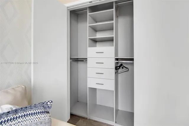 a bathroom with a sink vanity and toilet